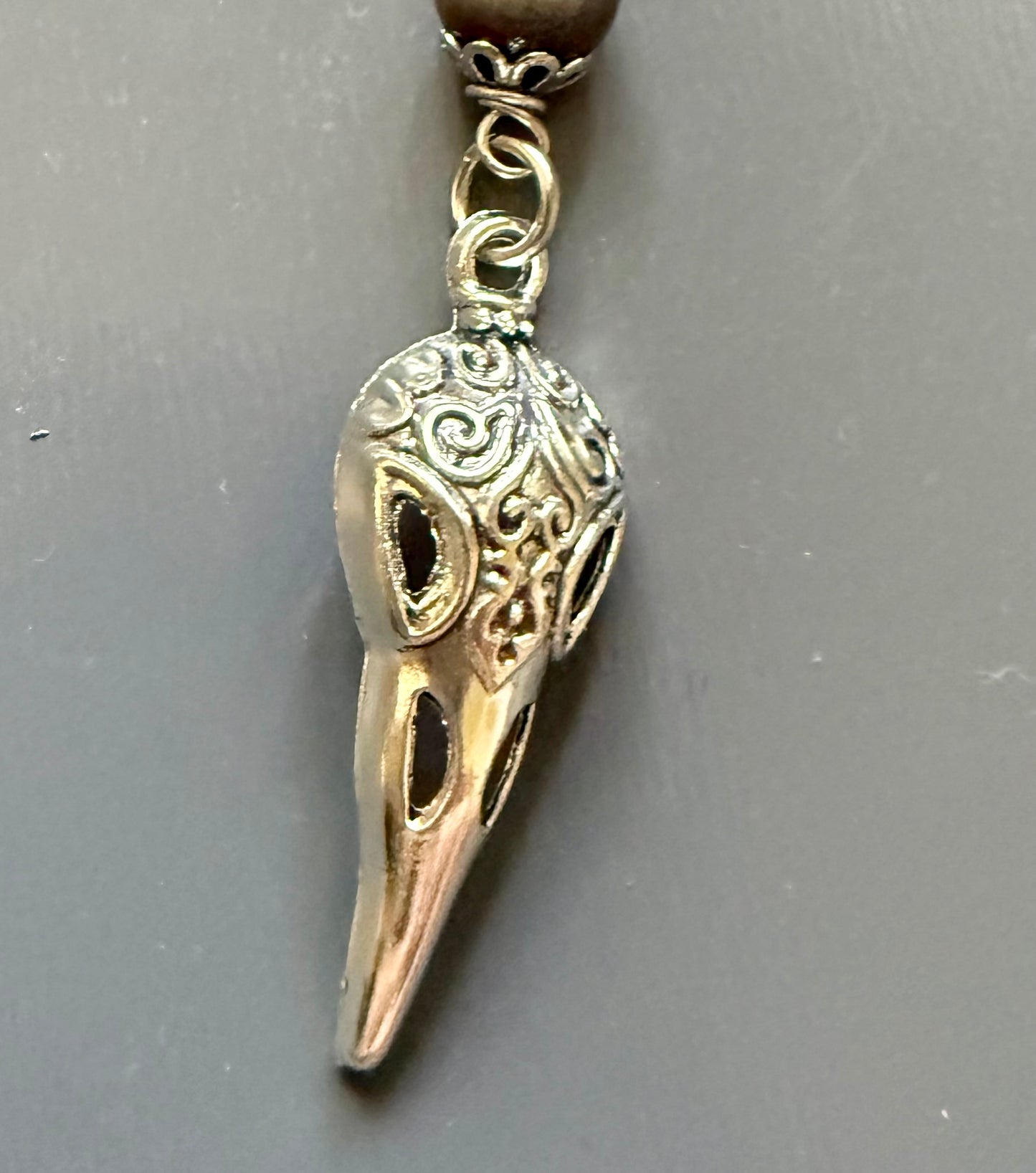 The Morrigan Devotional Prayer Beads with Crow Skull, Goddess, and Triquetra Charms.
