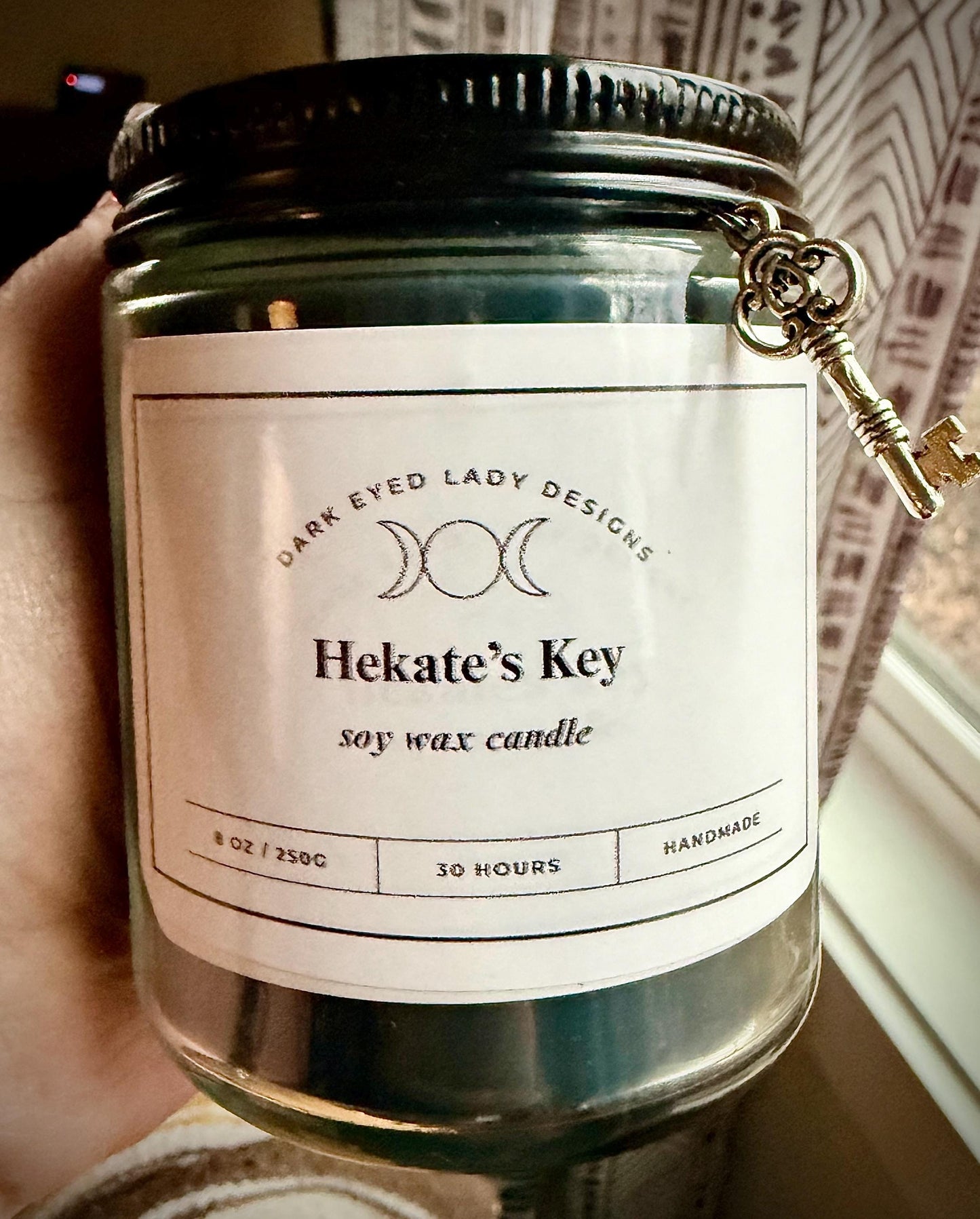 Goddess Hekate Black Soy Candle with Key Charm, Herbs, and Amethyst Crystal Chips.