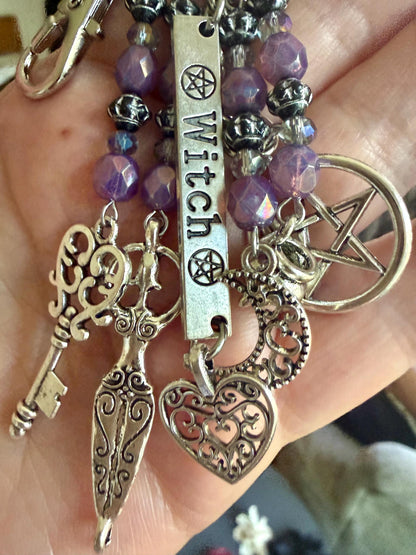 Witch Engraved Keychain Bag Charm with Iridescent Purple Beads and Witchy Charms.