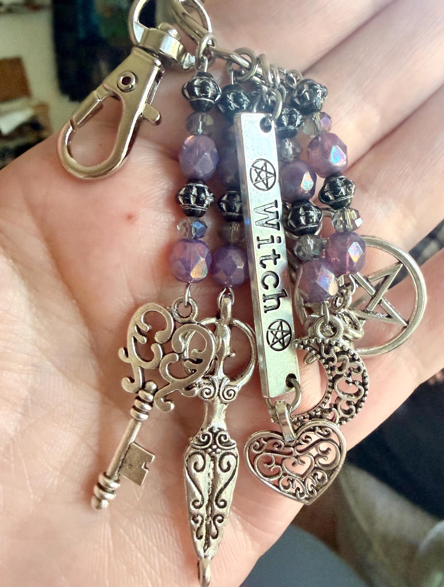 Witch Engraved Keychain Bag Charm with Iridescent Purple Beads and Witchy Charms.