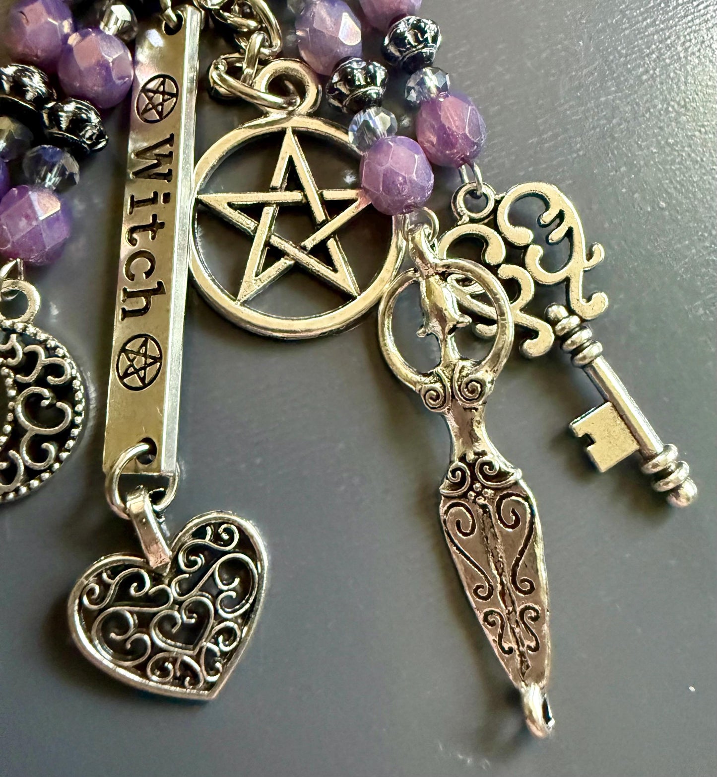 Witch Engraved Keychain Bag Charm with Iridescent Purple Beads and Witchy Charms.