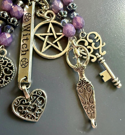 Witch Engraved Keychain Bag Charm with Iridescent Purple Beads and Witchy Charms.