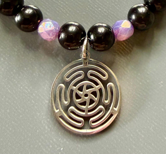 Hekate’s Wheel Devotional Bracelet with Obsidian and Iridescent Purple Glass Beads.