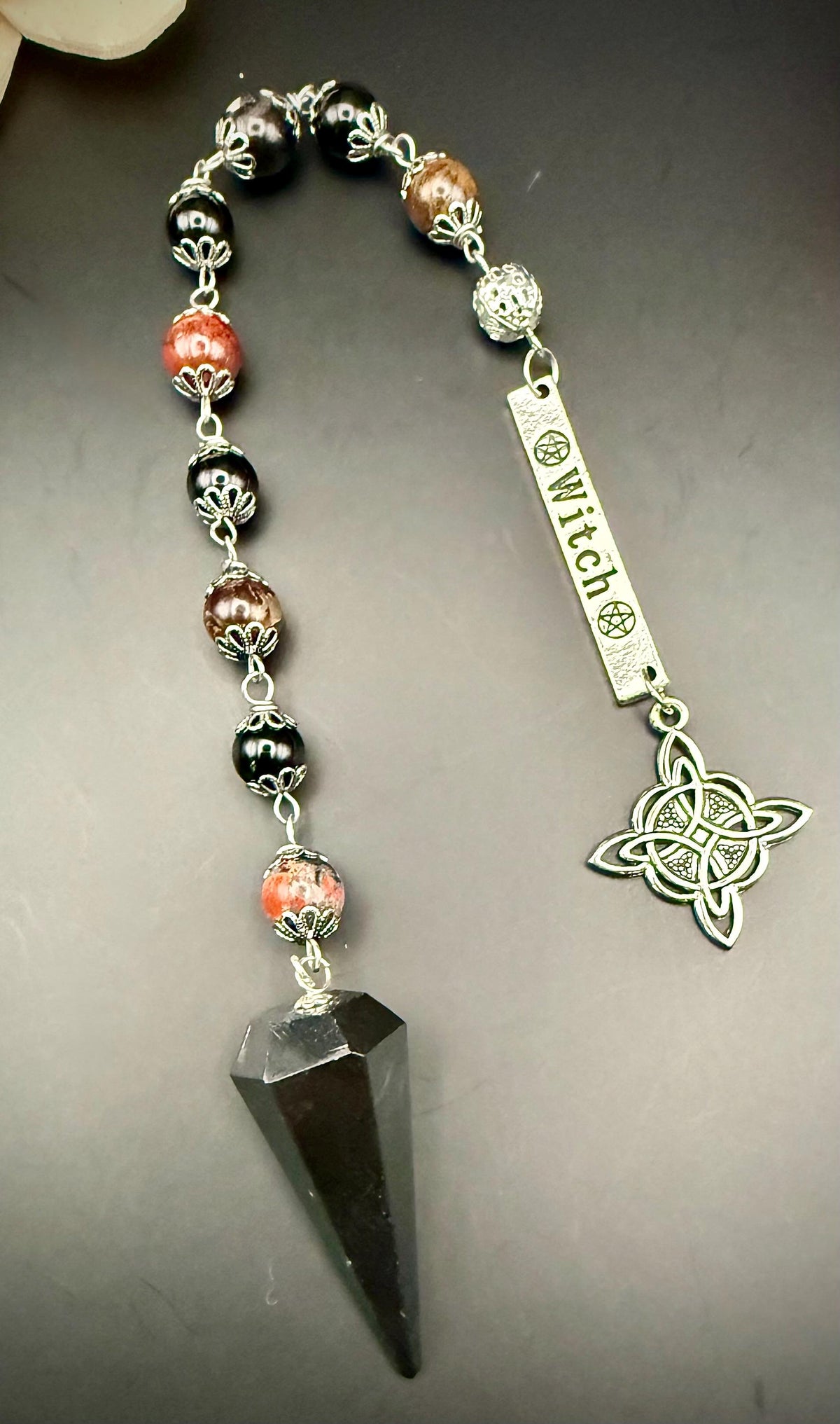 Tourmaline Point Pendulum with Red Brecciated Jasper, Obsidian, and Witch’s Knot Charm.