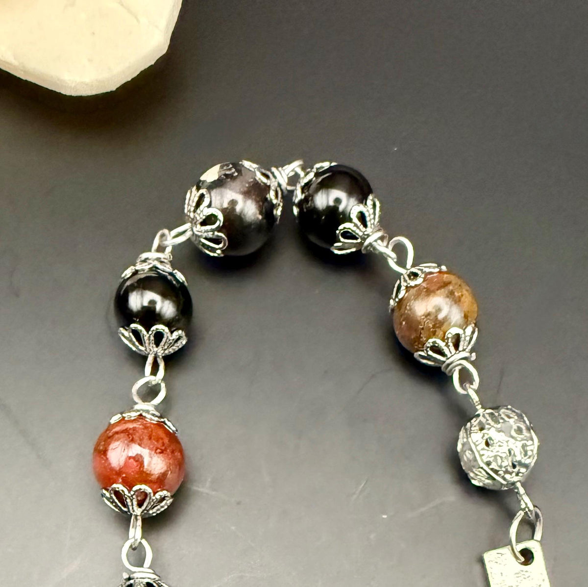 Tourmaline Point Pendulum with Red Brecciated Jasper, Obsidian, and Witch’s Knot Charm.