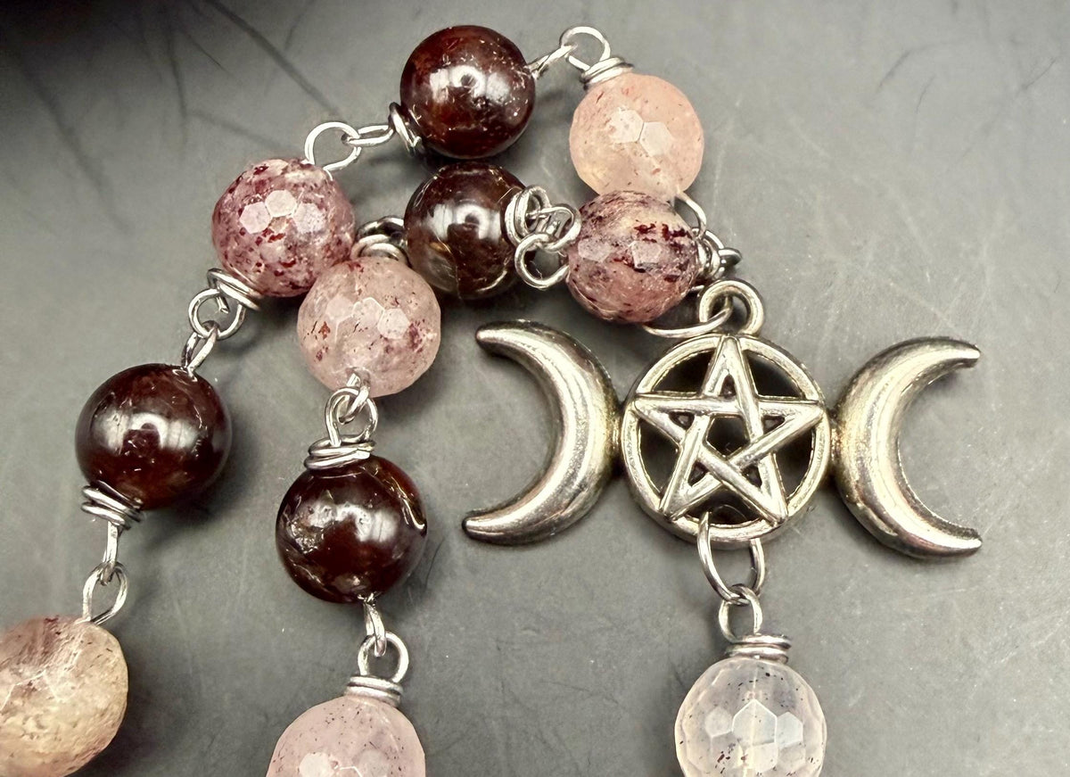 Witch’s Rosary: Strawberry Quartz, Garnet, Triple Moon, and Witch’s Knot Charm.