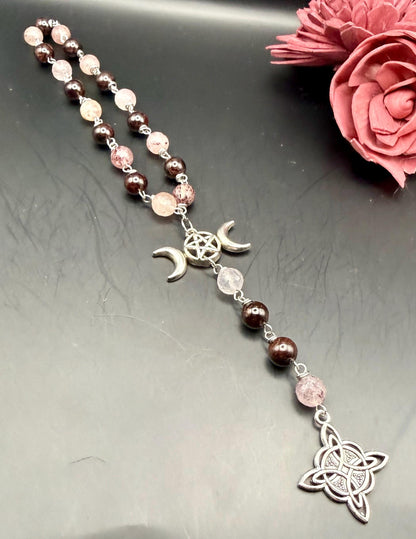 Witch’s Rosary: Strawberry Quartz, Garnet, Triple Moon, and Witch’s Knot Charm.
