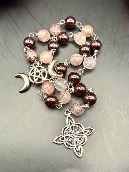 Witch’s Rosary: Strawberry Quartz, Garnet, Triple Moon, and Witch’s Knot Charm.
