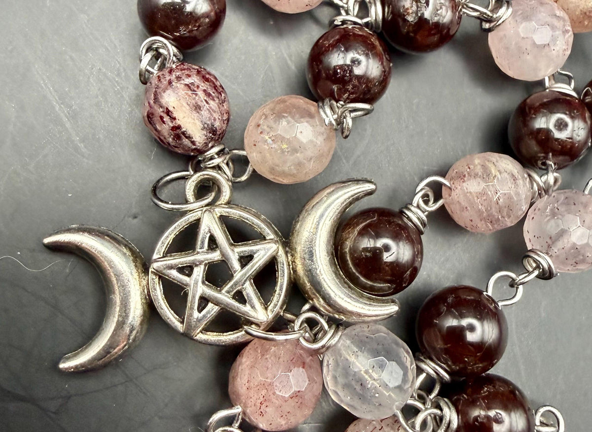 Witch’s Rosary: Strawberry Quartz, Garnet, Triple Moon, and Witch’s Knot Charm.