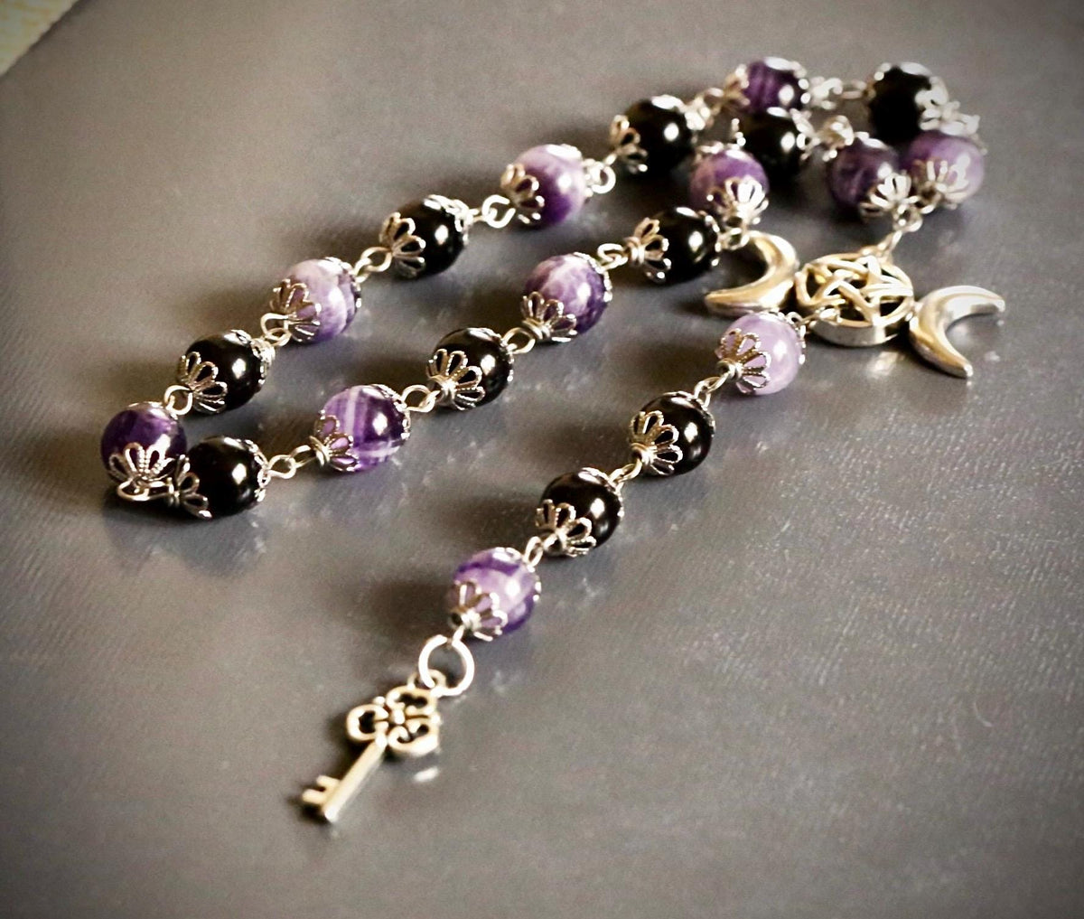 Goddess Hekate Devotional Altar Bundle with Witch’s Rosary, Pendulum , and Black Beeswax Pillar Candle.
