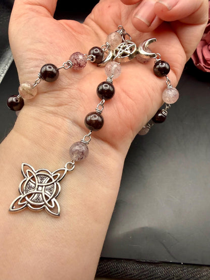 Witch’s Rosary: Strawberry Quartz, Garnet, Triple Moon, and Witch’s Knot Charm.