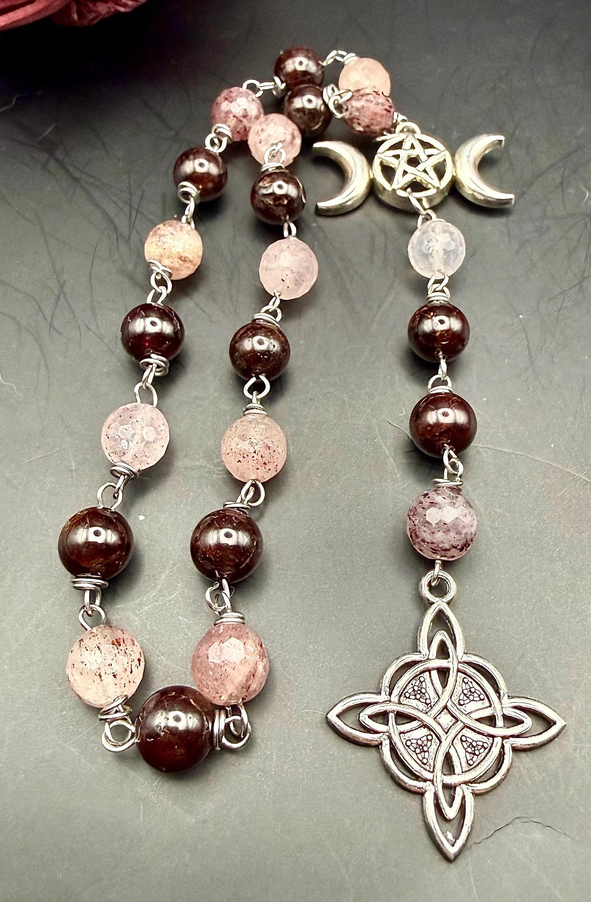 Witch’s Rosary: Strawberry Quartz, Garnet, Triple Moon, and Witch’s Knot Charm.