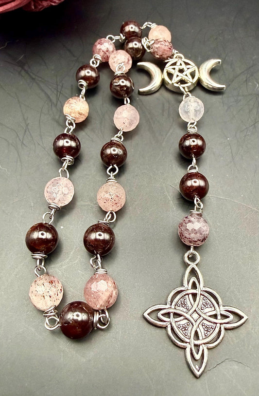 Witch’s Rosary: Strawberry Quartz, Garnet, Triple Moon, and Witch’s Knot Charm.