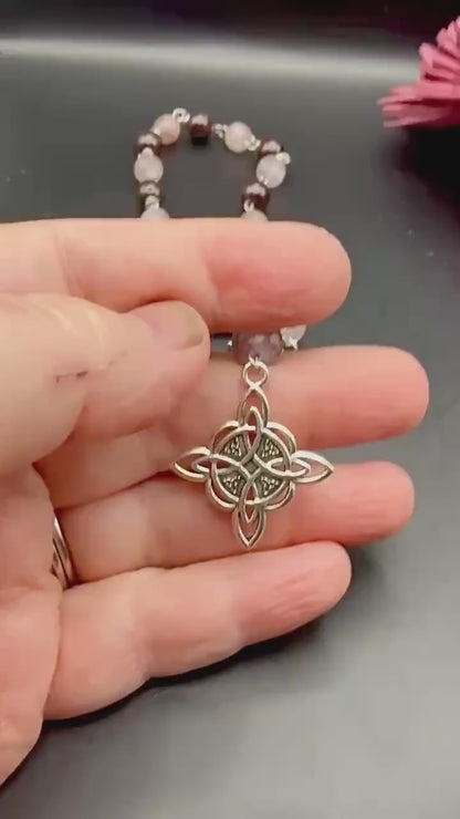 Witch’s Rosary: Strawberry Quartz, Garnet, Triple Moon, and Witch’s Knot Charm.