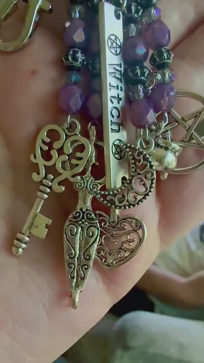 Witch Engraved Keychain Bag Charm with Iridescent Purple Beads and Witchy Charms.